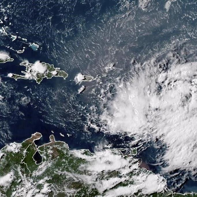 A strengthening Ernesto is poised to become a hurricane after brushing past Puerto Rico